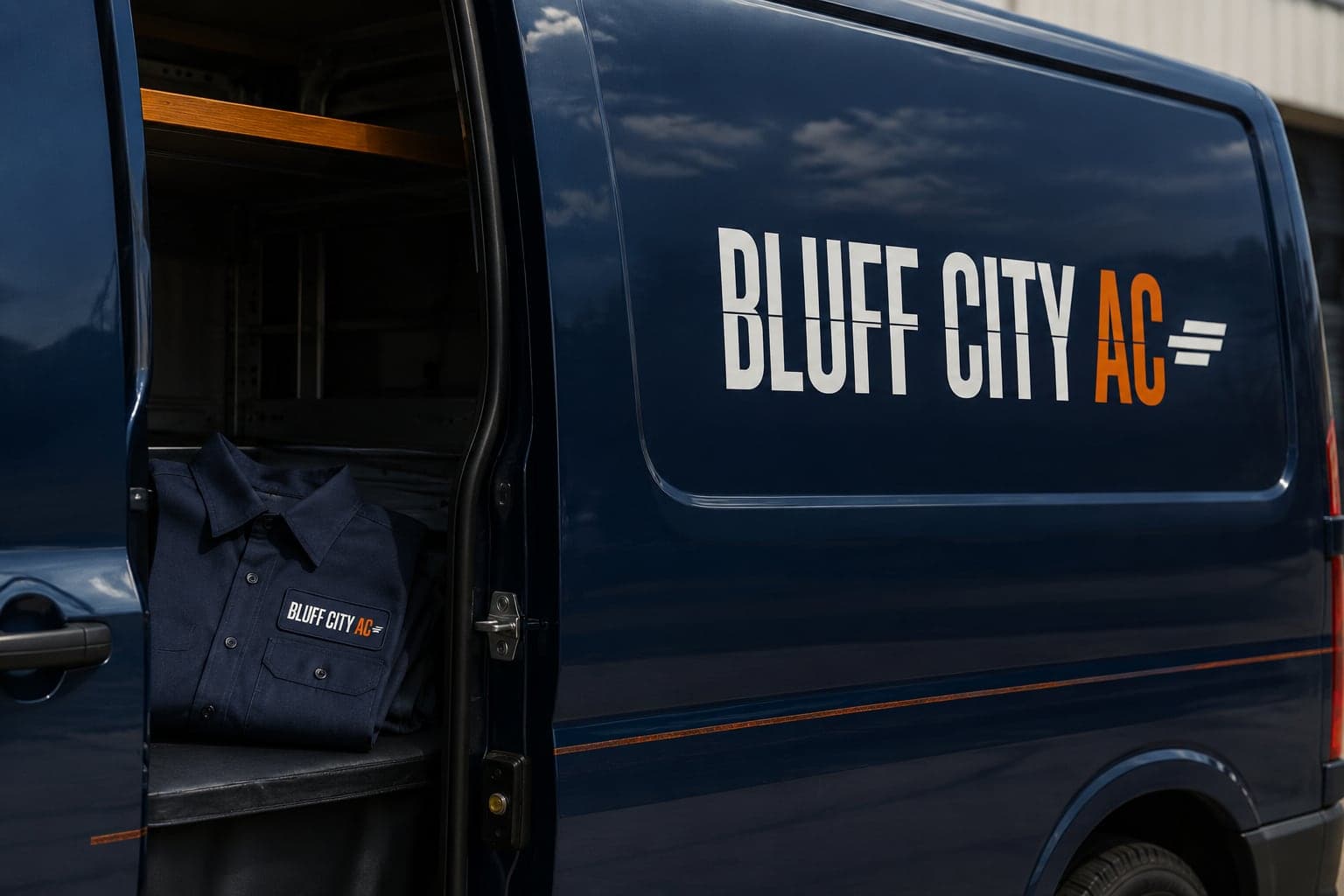 Bluff City AC logo on a service van and work shirt